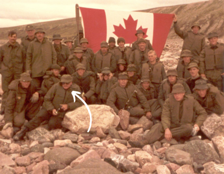 Picture of stephen gallant with soldiers in the artic holding Canadian flag
